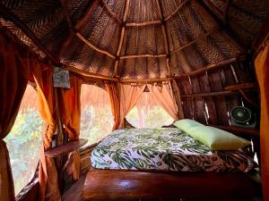 a small bed in a room with a window at Hostal Paraíso Tayrona Kogui in Santa Marta