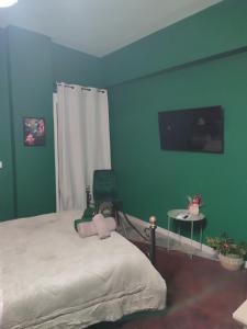 una camera da letto con un letto e una TV a parete di La Familia a Veria