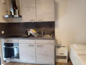 Kuchyň nebo kuchyňský kout v ubytování Moderne Apartments im Herzen von Osnabrück I private Tiefgarage I home2share + 58 fotografií