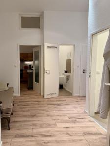 a hallway with white walls and wooden flooring at Gemütliche 3-Zimmer-Wohnung mit Parkplatz in Itzehoe +29 photos
