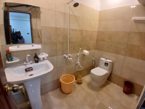 a bathroom with a sink and a toilet at Prime Star Hotel in Karachi