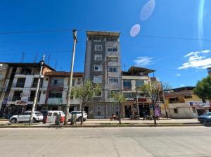 a tall building on the side of a street at Hotel Killasumaq in Cajamarca