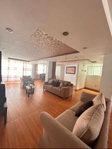 a living room with two couches and a couch at Hotel Killasumaq in Cajamarca +7 photos