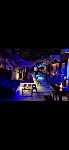 a restaurant with tables and benches at night at Argostoli`s Heard in Argostoli