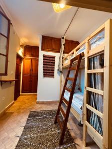 a room with two bunk beds and a ladder at hostel riad maqam in Essaouira