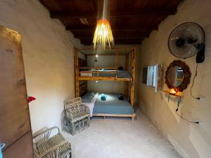 a small room with a bunk bed and a fan at Siwa Oracle Hostel in Siwa