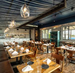 a restaurant with wooden tables and chairs in a room at Casa Azul Experience at The Perry in Key West
