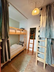 a bedroom with two bunk beds and a ladder at hostel riad maqam in Essaouira