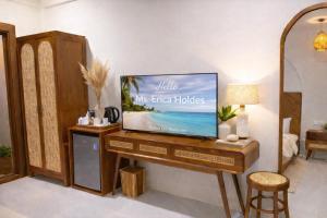 a television sitting on a wooden table in a room at Palma De Maldives in Thoddoo