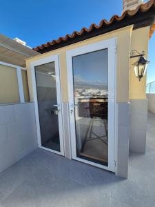 a sliding glass door on a house with a balcony at Paraiso View Duplex Penthouse in Callao Salvaje