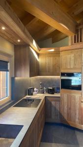 a kitchen with wooden cabinets and a counter top at Il fienile in Valfurva +12 photos