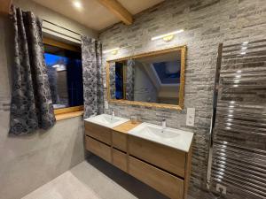 a bathroom with two sinks and a mirror at Nockalm Cottage in Bad Kleinkirchheim +123 photos