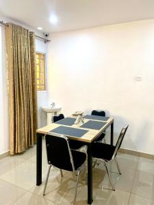 a dining room with a table and chairs at Adonai Guesthouse in Agbara