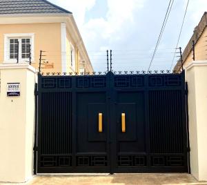 a black garage door in front of a house at Adonai Guesthouse in Agbara +1 photo