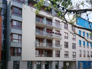 an apartment building with balconies on the side of it at Apartament z widokiem na dworek in Gdańsk