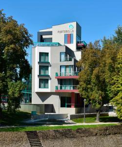 a building with a sign on the side of it at Portobello Wellness & Yacht Hotel Esztergom in Esztergom