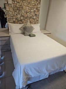 En eller flere senge i et værelse på Elitha Boutique Bed and Breakfast