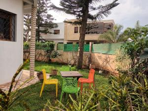 four colorful chairs around a table in a yard at Villa Hay Riad - Harhoura in Temara