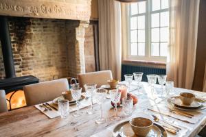 a long table with glasses and silverware on it at Eikenbrand in Veurne