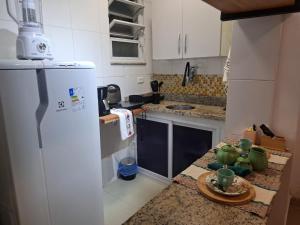 a kitchen with a white refrigerator and a counter top at Studio Lapa in Rio de Janeiro