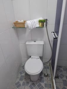 a bathroom with a white toilet in a room at Studio Lapa in Rio de Janeiro