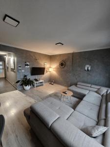 un soggiorno con un grande divano e un tavolo di Bracka Loft a Żywiec