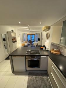 a kitchen with a black counter top in a room at Apartment AlcudiaMar in Alcudia