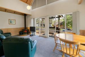 a living room with a table and a couch at Settle @ Sawmill in Mount Buller +10 photos