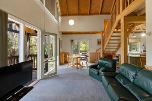 a living room with a couch and a table at Settle @ Sawmill in Mount Buller