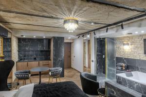 a room with a kitchen and a table and chairs at Basanavičiaus apartament in Vilnius +72 photos