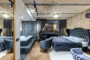 a bedroom with a large bed and a bath tub at Basanavičiaus apartament in Vilnius