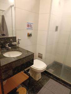 a bathroom with a toilet and a sink at Studio Centro - 7 Copas in Rio de Janeiro +35 photos