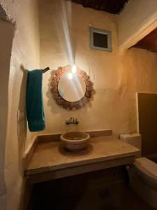 a bathroom with a sink and a mirror on the wall at Siwa Oracle Hostel in Siwa