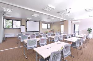 an empty classroom with tables and chairs in a classroom at Absolutum Wellness Hotel in Prague