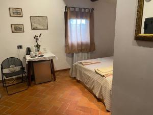 een slaapkamer met een bed, een tafel en een raam bij Casale Monte Oliviero - Bike Friendly B&B in Rome