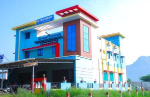 a building with a colorful front of it at JR Residency in Usilampatti