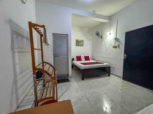 a living room with a bed and a chair at Dee Ella hotel in Danowita +19 photos