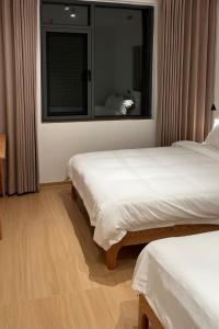 Postel nebo postele na pokoji v ubytování huazhi