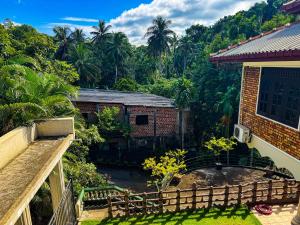 a view from the balcony of a house with trees at Dee Ella hotel in Danowita