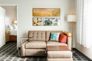 a living room with a couch and a bed at TownePlace Suites by Marriott Toledo Perrysburg in Perrysburg