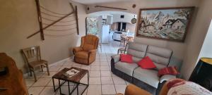 a living room with a couch and a table at Les Balcons de Valezan in La Plagne Tarentaise