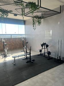 a gym with several tread machines and a camera at Studio Sereno in Barbacena +7 photos
