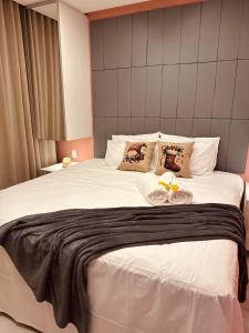 a large white bed with two pillows on it at Mahalo Exclusive Boutique in Maragogi +33 photos