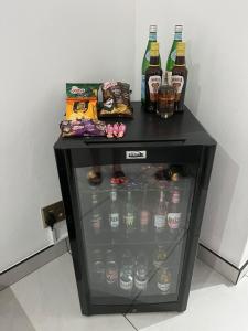 a small black table with bottles of alcohol on it at Malibu Dream in Gqeberha +4 photos
