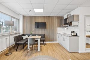 a kitchen and dining room with a table and chairs at HanseStay Wandsbek in Hamburg