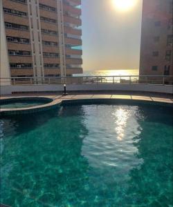 a large swimming pool in front of two tall buildings at Apartamento Exclusivo com Vista Mar no Number One Flat in São Luís