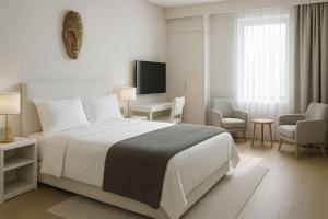 een witte slaapkamer met een bed en een tv en stoelen bij Derganda VL in Fier