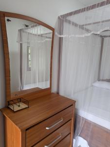 a wooden dresser with a mirror on top of it at Condo NÖJE in Weligama +92 photos