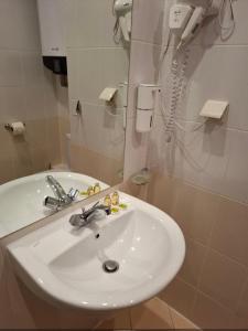 a bathroom with a white sink and a phone at Cozy studio 125 in Villa Park in Borovets +20 photos