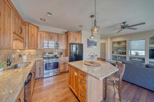 a kitchen with wooden cabinets and a large kitchen island at Riverfront Perch, w Balcony over the River in Salida